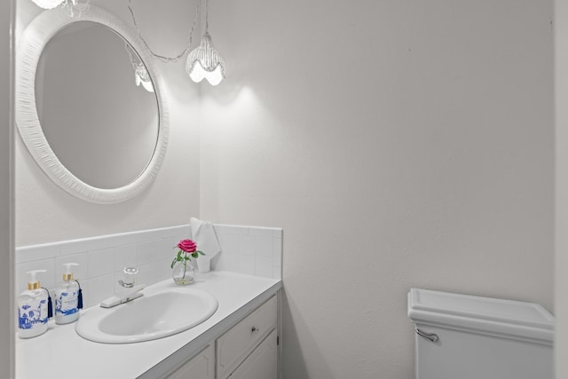9408 Cromwell Ter, Odessa, TX 79764 - bathroom with toilet, tasteful backsplash, and vanity