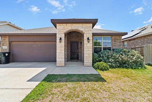 6907 Brite Rd, Odessa, TX 79765 - view of front of home with brick siding, a garage, concrete driveway, a shingled roof, and stone siding