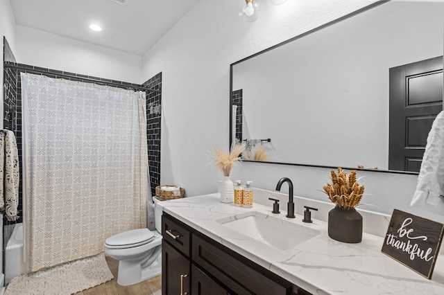 bathroom featuring toilet, shower / bath combination with curtain, wood finished floors, and vanity