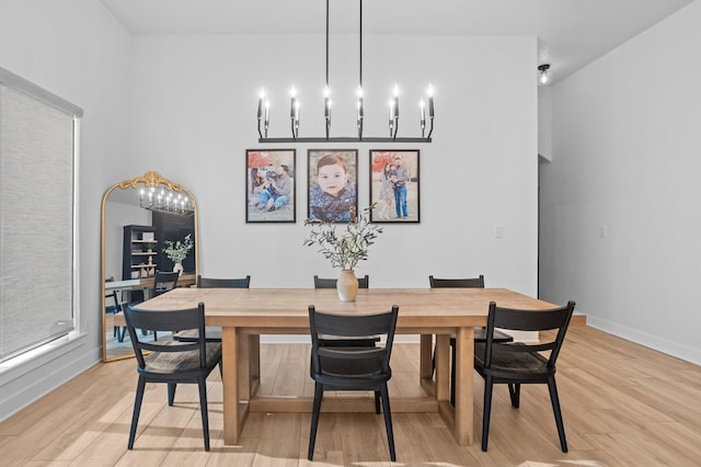 dining space featuring baseboards and light wood-style floors
