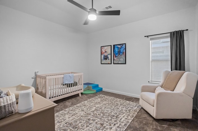 bedroom featuring a nursery area, carpet floors, a ceiling fan, baseboards, and visible vents