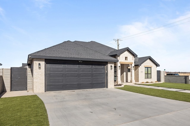 view of front of house featuring a garage, fence, and driveway