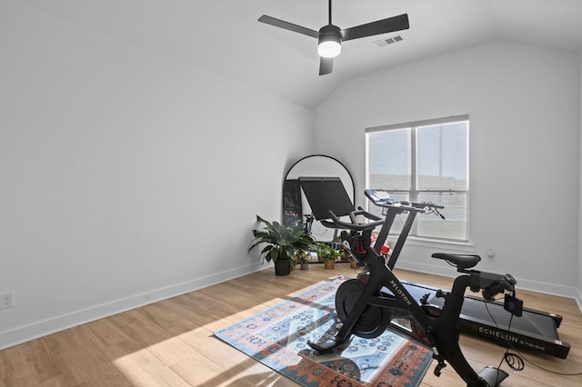 exercise area featuring visible vents, ceiling fan, wood finished floors, and lofted ceiling