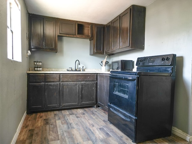 1431 S Alleghaney Ave, Odessa, TX 79761 - kitchen featuring black electric range oven, a sink, baseboards, dark brown cabinets, and light countertops