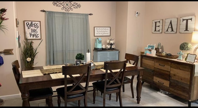 dining space with light tile patterned floors