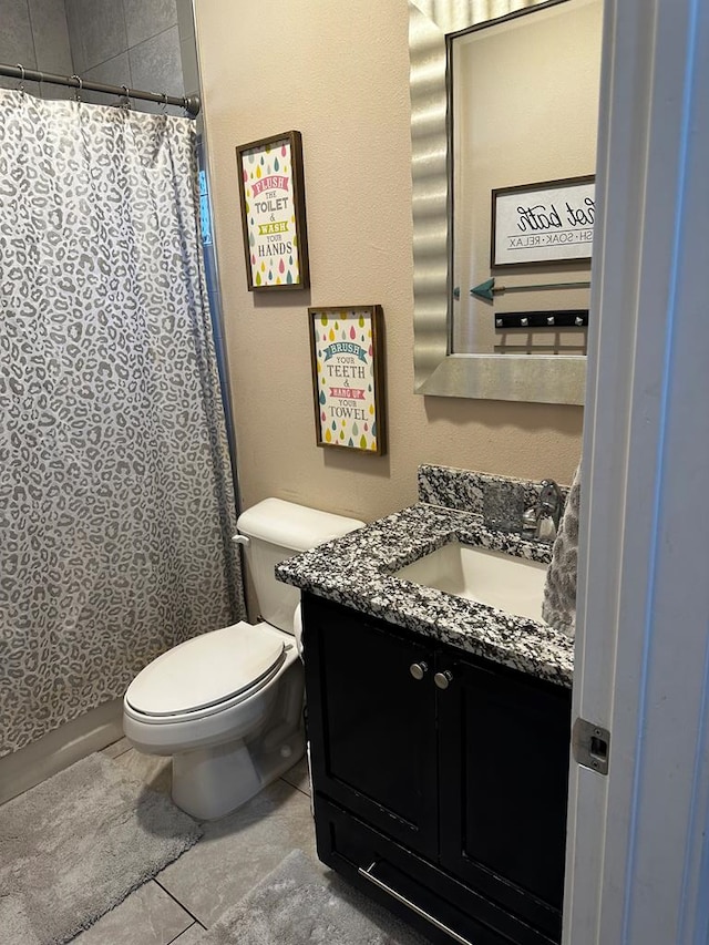 full bathroom with vanity, toilet, a shower with shower curtain, and tile patterned floors