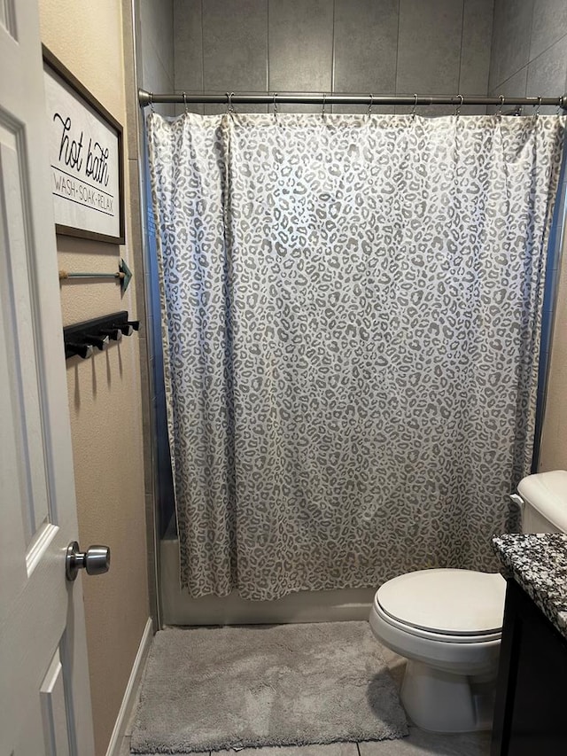 full bathroom featuring toilet, shower / bath combo with shower curtain, and vanity