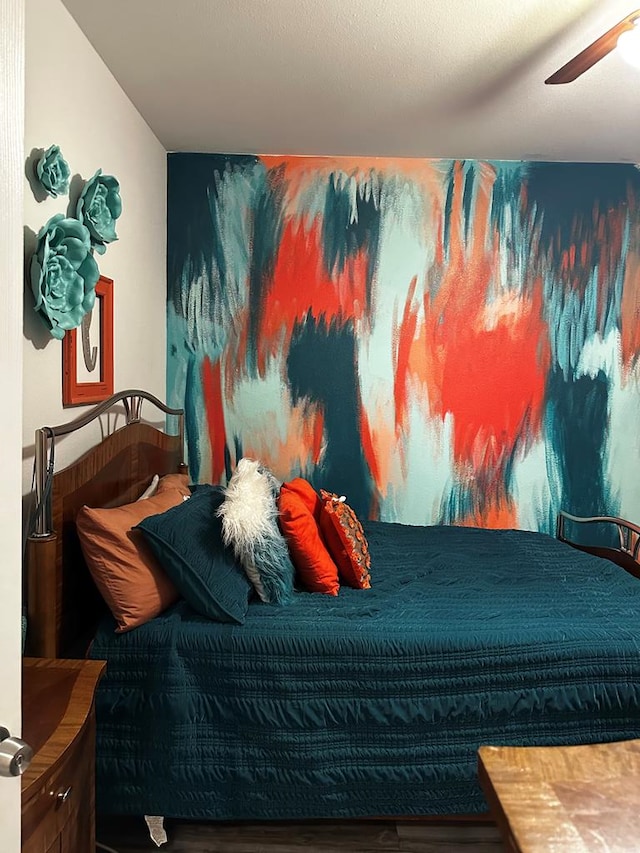 bedroom with wood finished floors and a ceiling fan