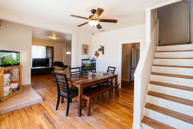 603 N 11th St, Alpine, TX 79830 - dining room featuring light wood finished floors, stairway, and a ceiling fan
