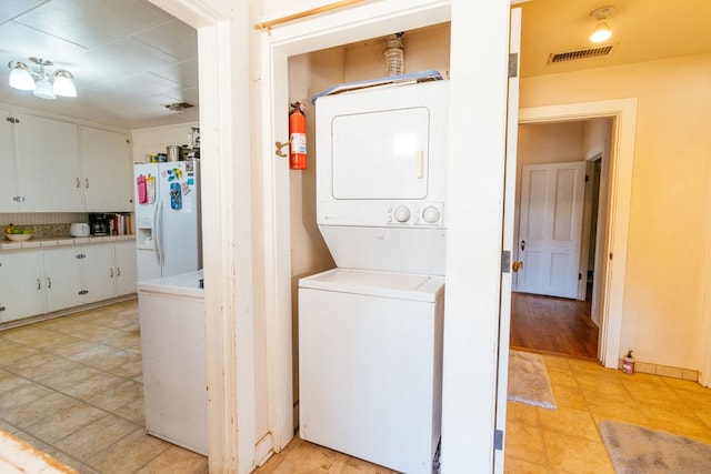 603 N 11th St, Alpine, TX 79830 - laundry room featuring stacked washer and clothes dryer