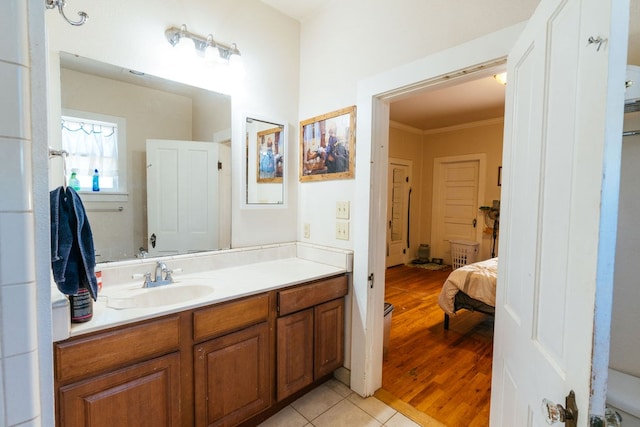 603 N 11th St, Alpine, TX 79830 - bathroom featuring vanity, ornamental molding, wood finished floors, and ensuite bath