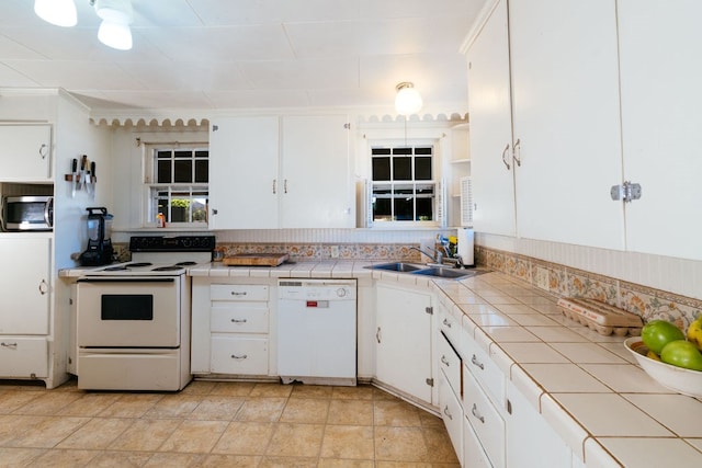 603 N 11th St, Alpine, TX 79830 - kitchen featuring white appliances, tile counters, white cabinets, and backsplash
