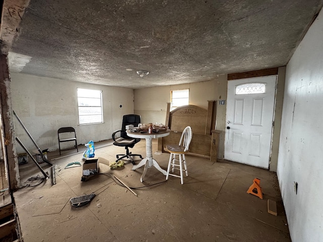 interior space featuring a wealth of natural light and a textured ceiling