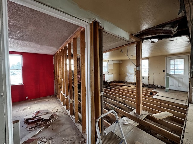 miscellaneous room with a textured ceiling and a healthy amount of sunlight