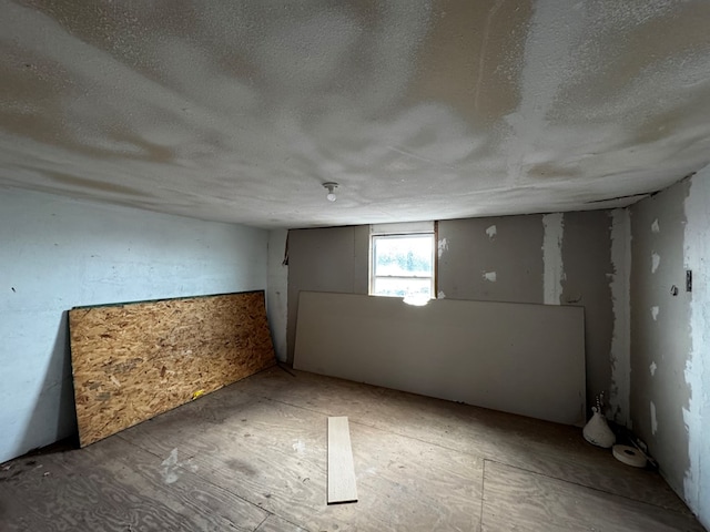 basement featuring a textured ceiling