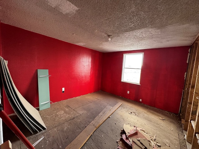 unfurnished room featuring a textured ceiling