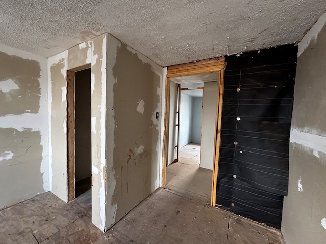 hallway with a textured ceiling