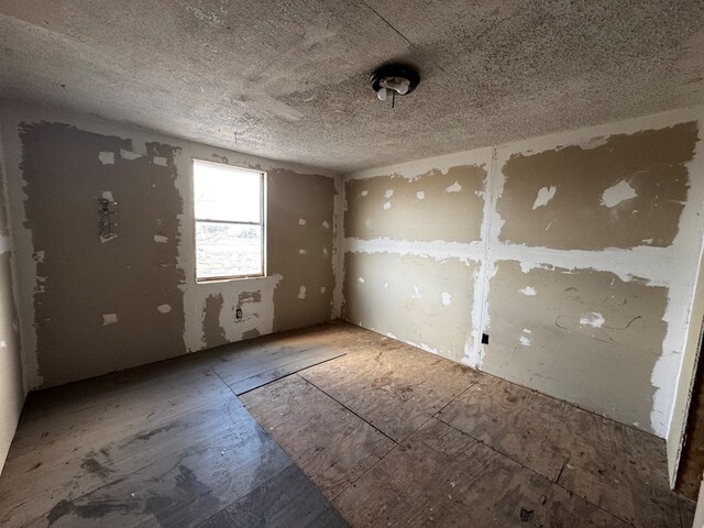 spare room with a textured ceiling