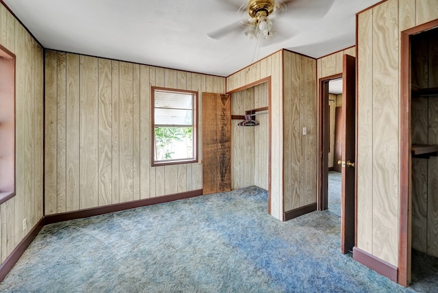unfurnished bedroom with carpet flooring, baseboards, and ceiling fan