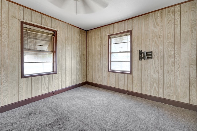 carpeted empty room featuring ceiling fan