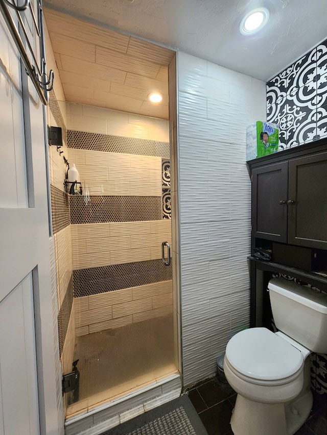 full bathroom featuring toilet, tile patterned floors, recessed lighting, and a shower stall