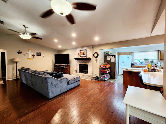 living room featuring visible vents, a fireplace, recessed lighting, a ceiling fan, and dark wood finished floors
