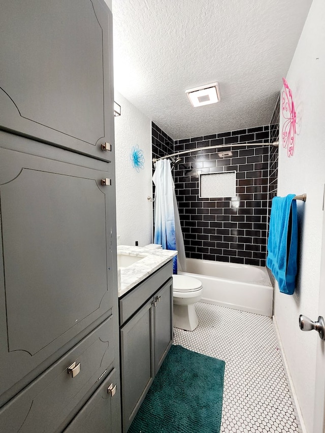 full bath featuring a textured ceiling, shower / bath combination with curtain, tile patterned flooring, vanity, and toilet