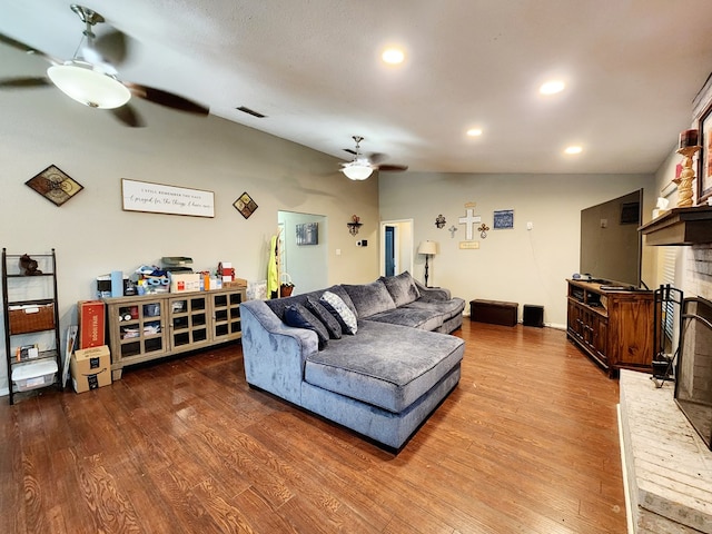 living area with ceiling fan, wood finished floors, and lofted ceiling