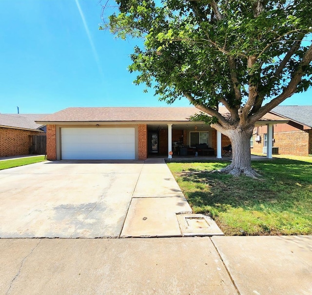 ranch-style home featuring an attached garage, covered porch, brick siding, and concrete driveway