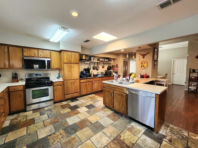 kitchen featuring a sink, a skylight, stainless steel appliances, and visible vents