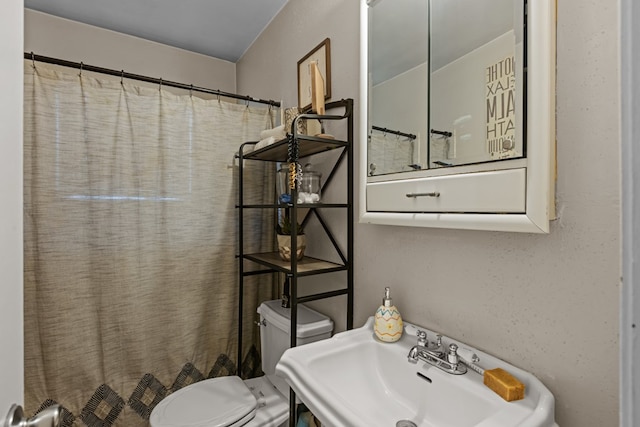 1306 Douglas Dr, Odessa, TX 79762 - bathroom with a sink, toilet, and a shower with curtain