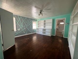unfurnished living room featuring baseboards, ceiling fan, and wood finished floors