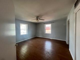 unfurnished bedroom with baseboards, ceiling fan, and dark wood-style floors
