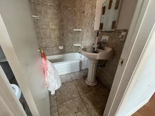 full bathroom with tile patterned floors and washtub / shower combination