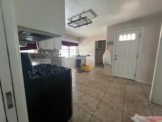kitchen featuring tile patterned flooring and black range with gas stovetop