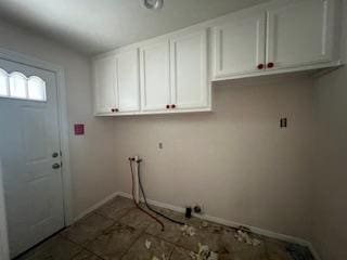 washroom with cabinet space and baseboards