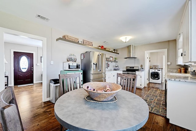 dining room featuring dark hardwood / wood-style floors and washer / dryer