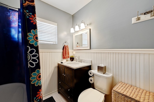 bathroom with tile patterned floors, vanity, and toilet