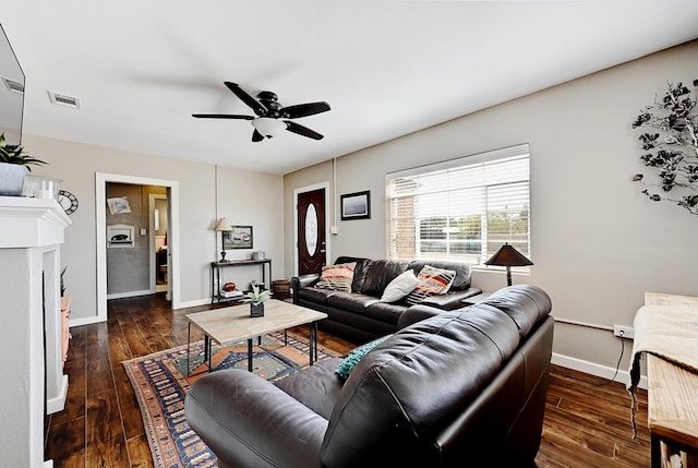 living room featuring dark hardwood / wood-style flooring and ceiling fan