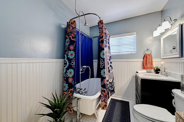 bathroom with tile patterned flooring, vanity, and toilet