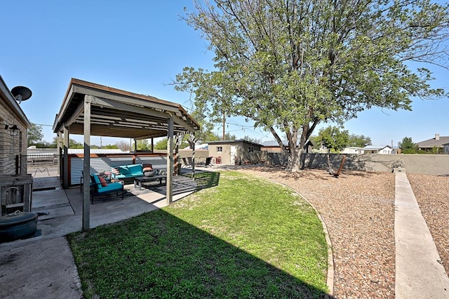 view of yard with an outbuilding, an outdoor living space, and a patio