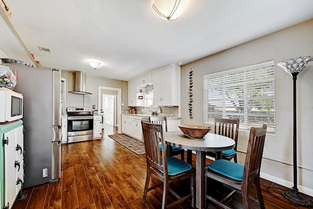 dining room with dark hardwood / wood-style flooring