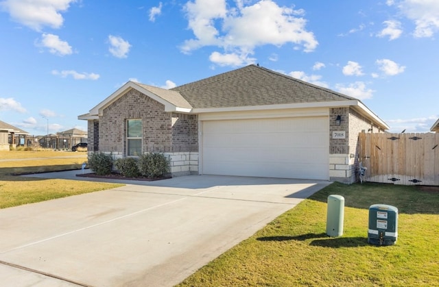 7018 Adenium Rd, Odessa, TX 79765 - view of front of home featuring brick siding, concrete driveway, a garage, and a shingled roof
