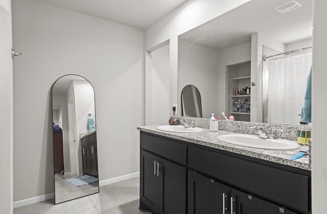 7018 Adenium Rd, Odessa, TX 79765 - bathroom featuring double vanity and tile patterned floors