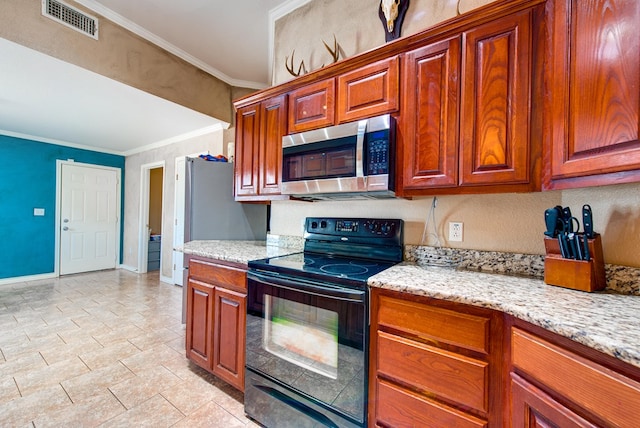 8625 Harvard Ave, Odessa, TX 79765 - kitchen featuring electric range, stainless steel microwave, ornamental molding, light stone counters, and brown cabinets