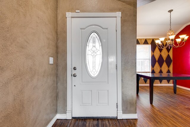 8625 Harvard Ave, Odessa, TX 79765 - foyer with dark wood finished floors, a chandelier, plenty of natural light, and a textured wall