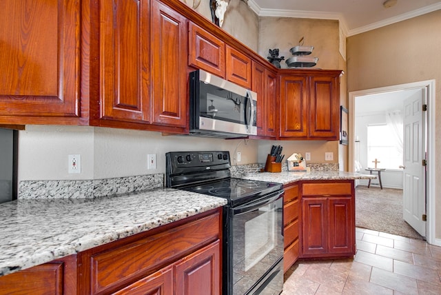 8625 Harvard Ave, Odessa, TX 79765 - kitchen with stainless steel microwave, black range with electric cooktop, crown molding, light stone countertops, and light carpet