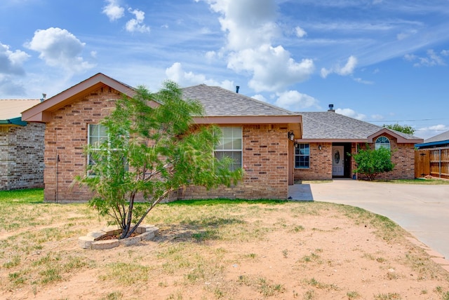 8625 Harvard Ave, Odessa, TX 79765 - ranch-style house featuring a shingled roof and brick siding