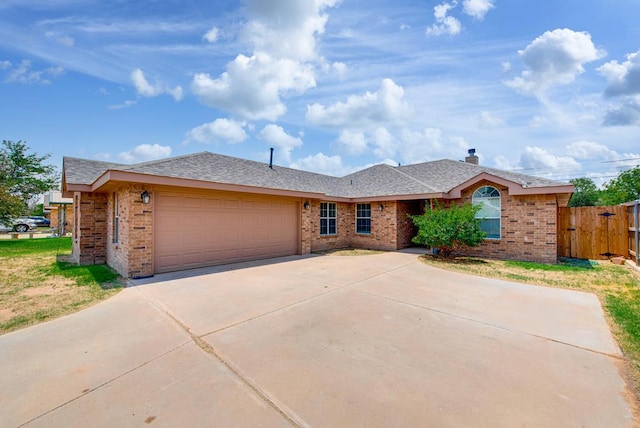 8625 Harvard Ave, Odessa, TX 79765 - ranch-style home featuring brick siding, a garage, driveway, and a gate