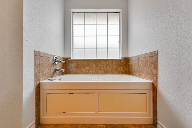 8625 Harvard Ave, Odessa, TX 79765 - full bath featuring a textured wall and a bath